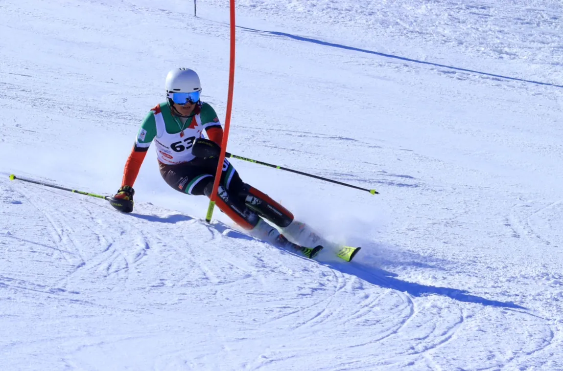Alex Astridge racing slalom in UAE race suit, bib 63