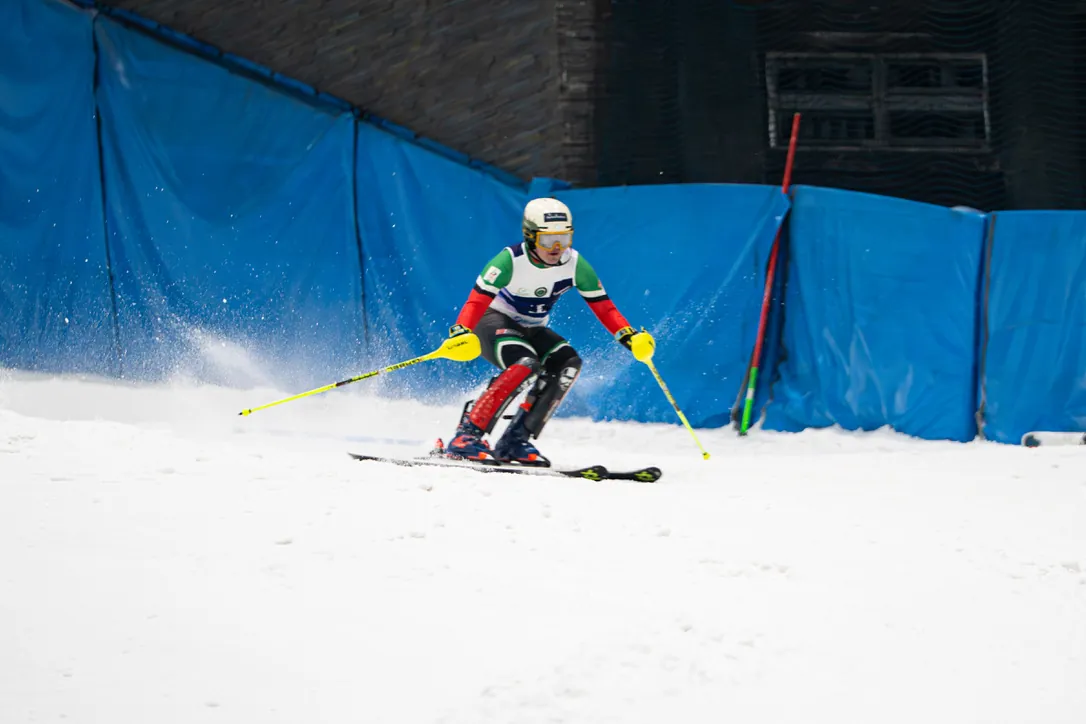 Alex Astridge racing through gates on the indoor slope at Ski Dubai